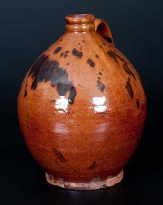 Two Pieces of American Redware, Jug and Plate, 19th century.