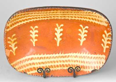 Redware Loaf Dish with Profuse Slip Decoration, Eastern U.S. Origin.