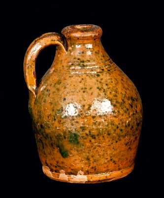 Small Ovoid Redware Jug with Copper Spots