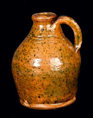 Small Ovoid Redware Jug with Copper Spots