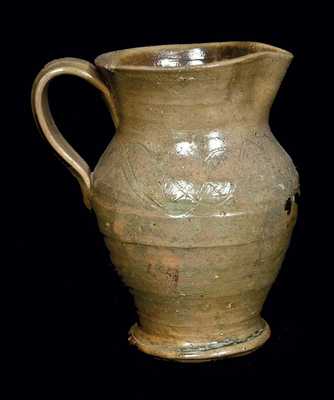 Unusual Footed Stoneware Pitcher with Incised Lines, North Carolina Origin