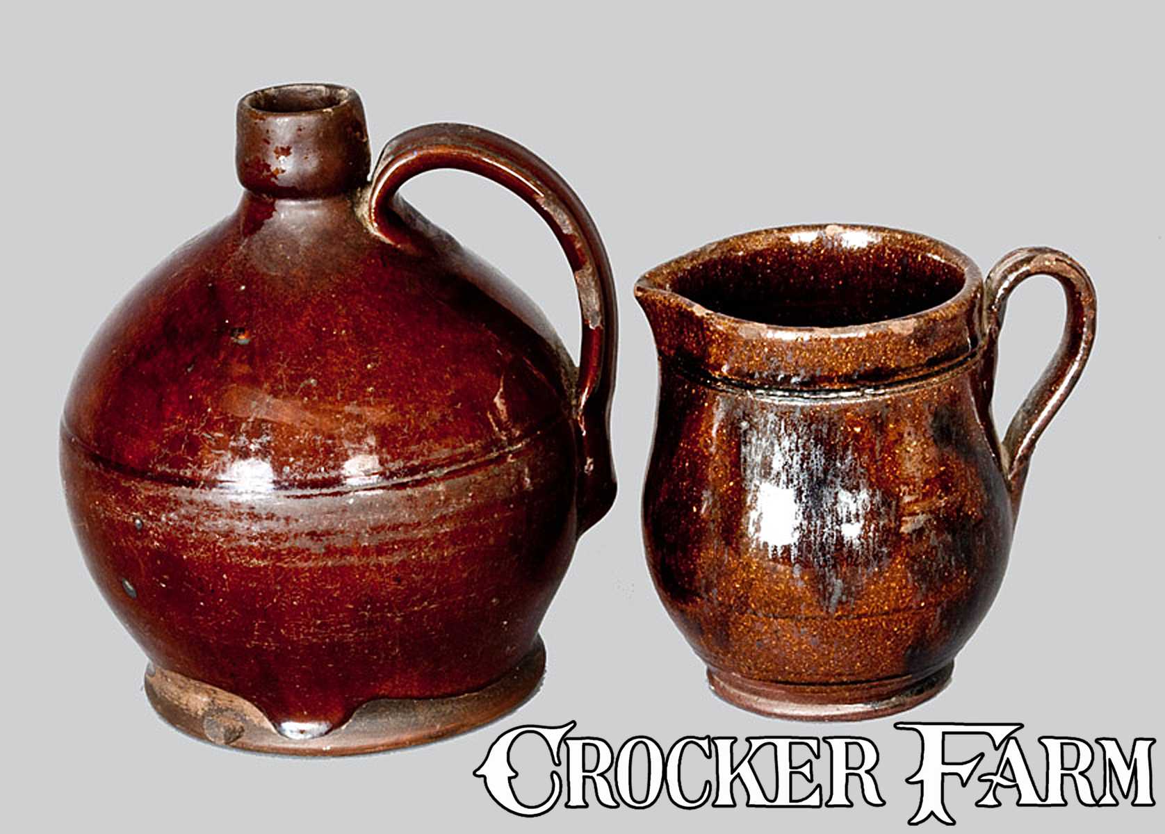 Lot of Two: Small Redware Jug and Redware Cream Pitcher -- Lot 281 ...