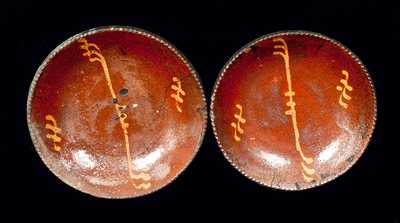 Near Pair of Pennsylvania Slip-Decorated Redware Plates