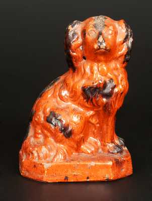 Glazed Redware Figure of a Spaniel, Pennsylvania origin, second half 19th century.
