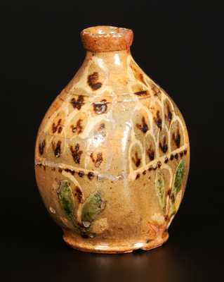 Exceptional Redware Pocket Flask with Three-Color Slip-Decorated Floral Designs