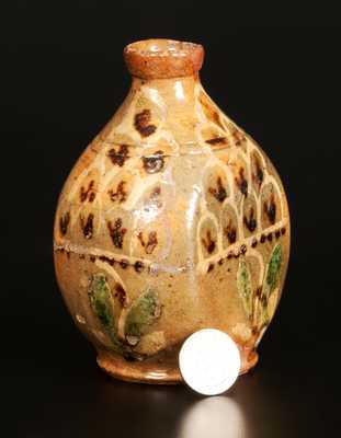 Exceptional Redware Pocket Flask with Three-Color Slip-Decorated Floral Designs