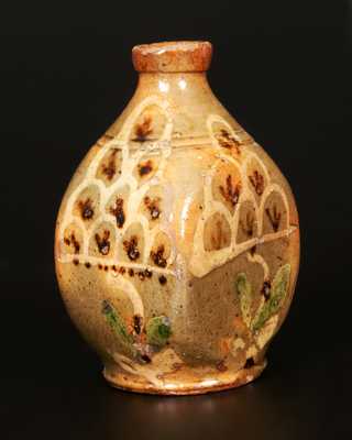 Exceptional Redware Pocket Flask with Three-Color Slip-Decorated Floral Designs