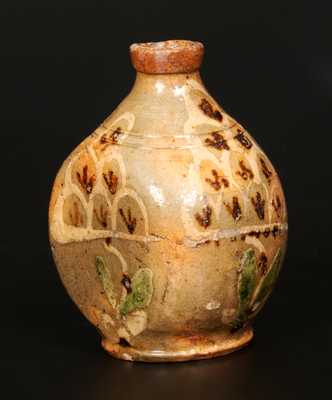 Exceptional Redware Pocket Flask with Three-Color Slip-Decorated Floral Designs