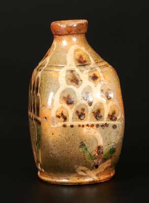 Exceptional Redware Pocket Flask with Three-Color Slip-Decorated Floral Designs