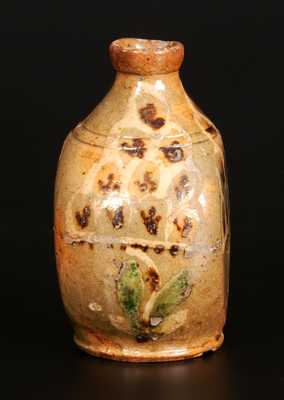 Exceptional Redware Pocket Flask with Three-Color Slip-Decorated Floral Designs