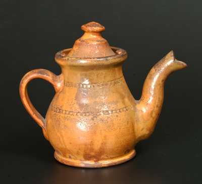 Unusual Redware Teapot with Coggled Decoration and Orange Slip Coating