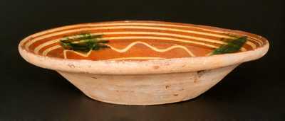 Redware Bowl with Elaborate Yellow Slip-Decorated Interior and Green Sponging