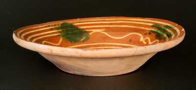 Redware Bowl with Elaborate Yellow Slip-Decorated Interior and Green Sponging