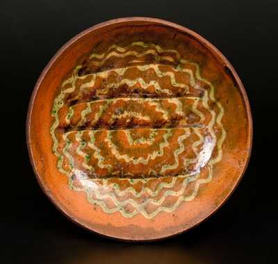 Slip-Decorated Pennsylvania Redware Plate with Three-Color Swirl Decoration