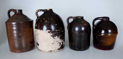 Lot of Four: Albany-Slip Stoneware Jugs incl. Peoria Pottery Example and Three Examples Found in Alabama