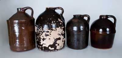 Lot of Four: Albany-Slip Stoneware Jugs incl. Peoria Pottery Example and Three Examples Found in Alabama