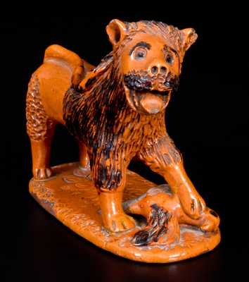 Exceedingly Rare Pennsylvania Redware Figure of a Lion Standing atop a Bird