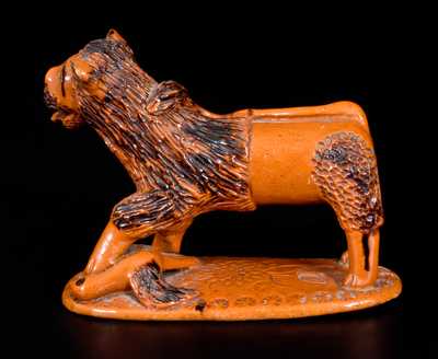 Exceedingly Rare Pennsylvania Redware Figure of a Lion Standing atop a Bird