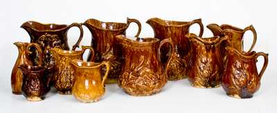 Lot of Eleven: American Rockingham Ware Pitchers in Various Patterns