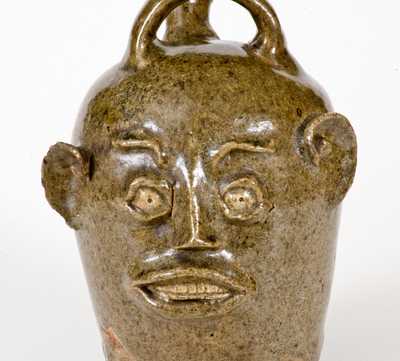 Extremely Rare and Important Edgefield, South Carolina, Stoneware Face Harvest Jug