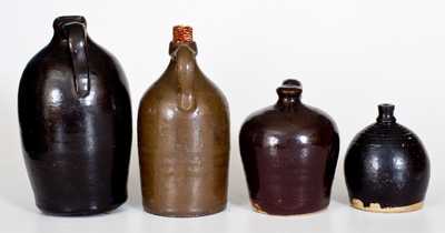 Lot of Four: Stoneware Vessels with Albany Slip Glaze incl. Chick Waterer, Bank, and Two Jugs