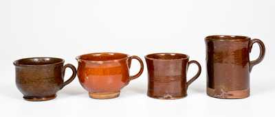 Four Glazed Redware Drinking Vessels, American, 19th century