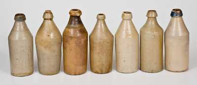 Lot of Seven: Stoneware Bottles incl. 5 with Impressed Advertising