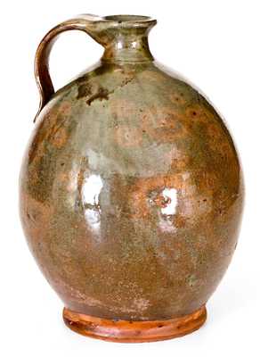 Exceptional Ovoid New England Redware Jug with Vibrant Glaze