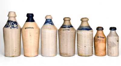 Lot of Seven: Stoneware Bottles with Cobalt Highlights and Impressed Names