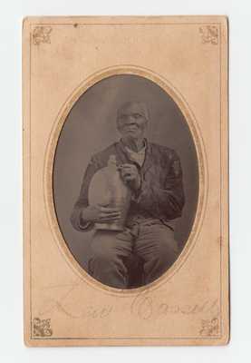 Very Rare Period Photograph of an African-American Man Holding a Stoneware Jug