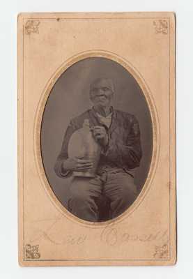 Very Rare Period Photograph of an African-American Man Holding a Stoneware Jug