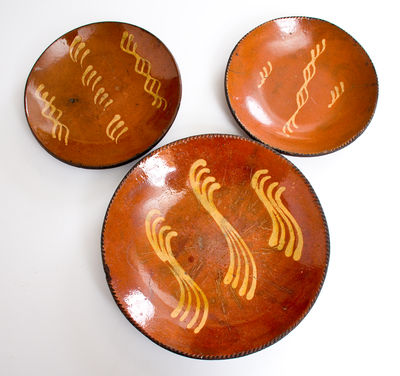 Lot of Three: Redware Plates with Yellow Slip Decoration