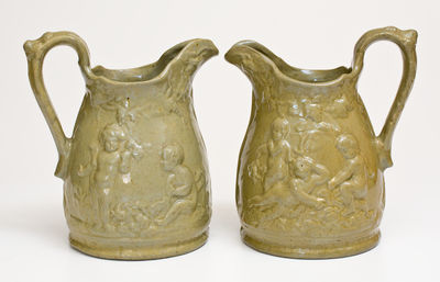 Extremely Rare Pair of JOHN BELL / WAYNESBORO Redware Pitchers with Molded Cherub Design