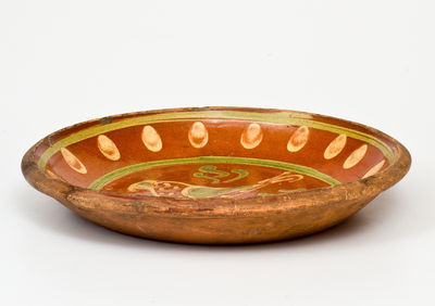 Exceptional Southeastern Pennsylvania Redware Dish with Two-Color Slip Bird Decoration, 1807