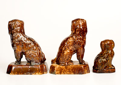 Three Rockingham-Glazed Spaniel Figures, second half 19th century