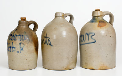 Three Cobalt-Decorated American Stoneware Advertising Jugs