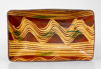 Exceptional Slip-Decorated Philadelphia, PA Redware Loaf Dish, fourth quarter 18th century.