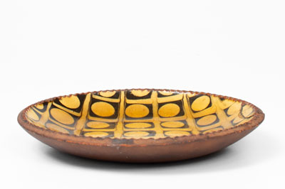 Exceptional Slip-Decorated Redware Plate, English origin, 18th or 19th century