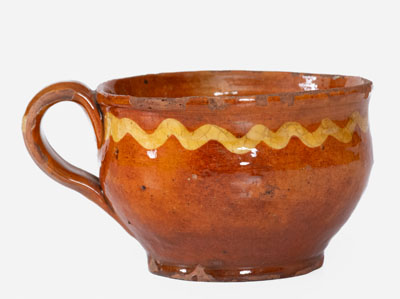 Extremely Rare Slip-Decorated Redware Cup, probably Charlestown, Massachusetts, 18th century
