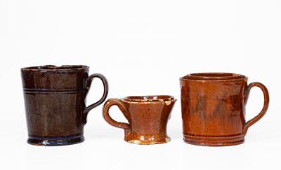Lot of Three: Glazed Redware Shaving Mugs, American, 19th century