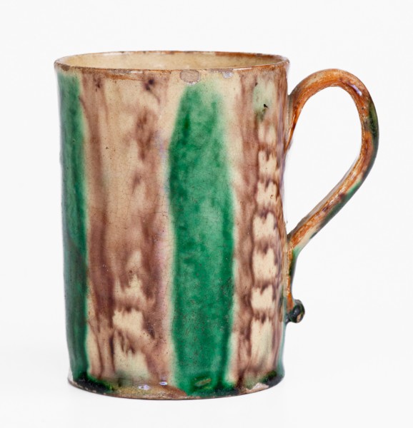 Glazed Redware Mug with Copper and Manganese Decoration, early 19th century.