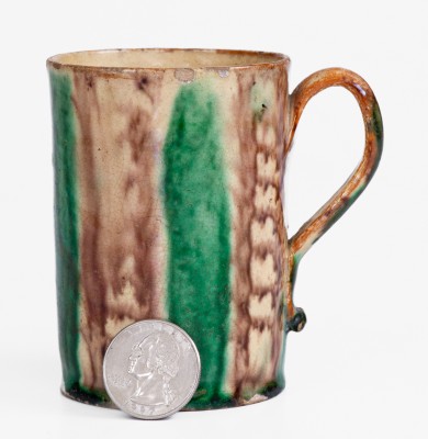 Glazed Redware Mug with Copper and Manganese Decoration, early 19th century.