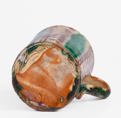 Glazed Redware Mug with Copper and Manganese Decoration, early 19th century.