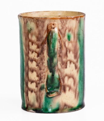 Glazed Redware Mug with Copper and Manganese Decoration, early 19th century.