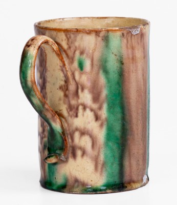 Glazed Redware Mug with Copper and Manganese Decoration, early 19th century.