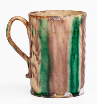 Glazed Redware Mug with Copper and Manganese Decoration, early 19th century.