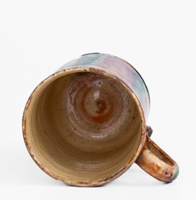 Glazed Redware Mug with Copper and Manganese Decoration, early 19th century.