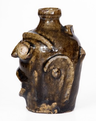 Rare Alkaline-Glazed Stoneware Face Jug, Edgefield District, SC origin, third quarter 19th century.