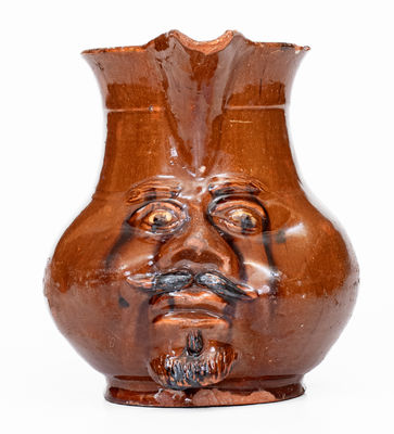 Extremely Rare Pennsylvania Redware Face Pitcher, 19th century