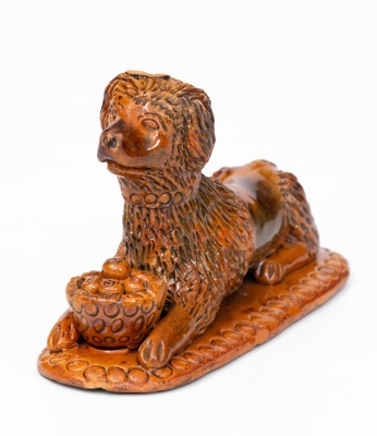 Rare and Important Redware Figure of a Dog with Basket, attrib. John Bell, Waynesboro, PA